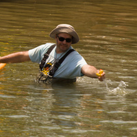 The race official pulls the winning duck out of the water